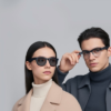 A man and a woman modeling stylish, modern eyewear frames to showcase contemporary fashion aesthetics.